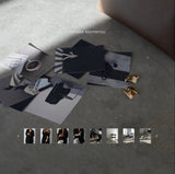 stock photo of editorial studio images with woman props including blazer, bag, and magazine in minimalist studio setting