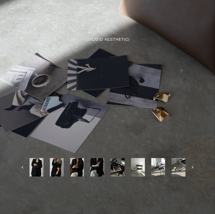 stock photo of editorial studio images with woman props including blazer, bag, and magazine in minimalist studio setting