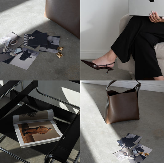 stock photo of editorial studio images with woman props including blazer, bag, and magazine in minimalist studio setting